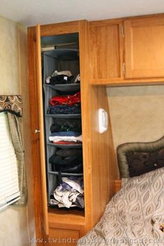 the closet is full of clothes and other things to use in this small bedroom area