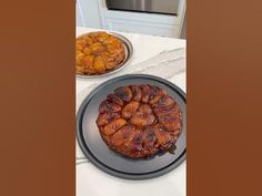 two plates with food on them sitting on a table