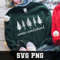 a green sweater with white trees and the words winter wonderland on it