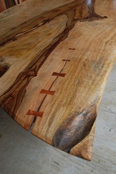 a wooden table that is made out of wood and has writing on it with arrows