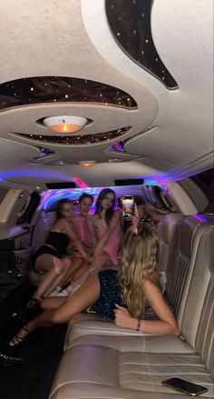 a group of women sitting in the back of a limo