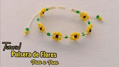 the beaded bracelet has yellow flowers and green beads on it, along with a white string