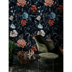 a chair and table in front of a wallpapered room with flowers on it