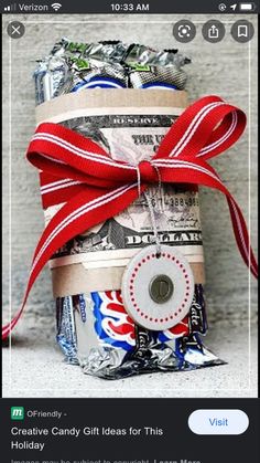 a stack of money wrapped in red, white and blue paper with a bow on top