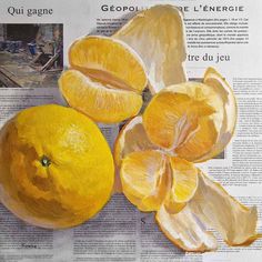 an orange cut in half sitting on top of a newspaper