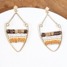 “Tribal Chandeliers” Stacked Beads Wooden Orange Cream Gold Stainless Steel V Ring Chain Dangles. These Beauties Feature A Gold V Ring Loop With Wooden, Cream, Orange, White, & Gold Beads Strung/Stacked Across The Center. The V Ring Hangs From 2 Delicate Gold Chains Attached To A Square/Diamond-Shaped Gold Stud. Stainless Steel. Hypoallergenic. Lead & Nickel Free. New. Measurements: Eardrop Length: 2.4” Earring Width: 1.2” If You Want It, Don’t Let It Get Away Send Me An Offer! I Love To Do Bund Bohemian Orange Wire Wrapped Jewelry, Bohemian Orange Jewelry Nickel Free, Bohemian Orange Nickel-free Jewelry, Bohemian Orange Teardrop Jewelry, Orange Teardrop Bohemian Beaded Earrings, Bohemian Orange Metal Jewelry, Brown Beaded Chain Dangle Jewelry, Brown Dangle Jewelry With Beaded Chain, Orange Beaded Dangle Jewelry