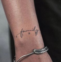 a woman's arm with a tattoo that reads, family and is on it