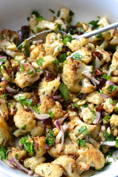 a white bowl filled with cauliflower and onions