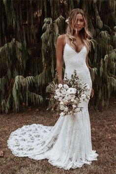 a woman in a wedding dress holding a bouquet