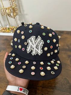 1 of 1 custom fitted inspired by yaito🪩 Custom Ny Hat, Custom Yankee Hat, Pearl Fitted Hat, Custom Fitted Hat, Custom Hat Ideas, Hat Customization, Bedazzled Hat, Custom New Era Hats, Custom Beanies