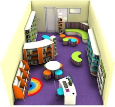 an aerial view of a library with tables, bookshelves and colorful rugs