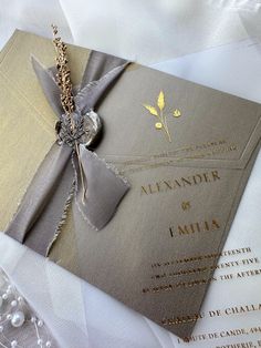 the wedding card is tied with a silver ribbon