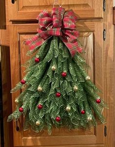 a christmas tree hanging on the front door