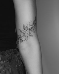 a woman with a flower tattoo on her arm