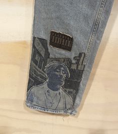 2pac Tribute Customized Denim Jeans - Triple Applique - Laser Engraving Finish - Light Blue 100% Cotton 285 Relaxed Fit 34W x 34L Blue Reworked Jeans For Streetwear, Reworked Recycled Denim Jeans For Streetwear, 90s Rigid Denim Jeans For Streetwear, 90s Style Rigid Denim Jeans For Streetwear, Reworked Retro Jeans For Streetwear, Reworked Denim Blue Jeans For Streetwear, Streetwear Dark Wash Reworked Jeans, Retro Reworked Jeans For Streetwear, Reworked Medium Wash Jeans For Streetwear