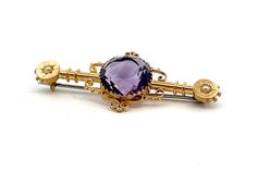 Pressed and assembled amethyst and pearl brooch. The brooch measures 50mm x 20.3mm and has a 13mm round cut amethyst in a multi claw mount at the centre and a half seed pearl star set at each end. The brooch is Hallmarked Birmingham 1916 and 15 and .625. The brooch weighs 5.3gms.  E9607 Antique Cabochon Brooch For Formal Occasions, Antique Cabochon Brooch For Formal Wear, Vintage Gemstone Round Brooches, Elegant Amethyst Brooches For Wedding, Vintage Gemstone Brooches For Formal Occasions, Victorian Round Brooches For Formal Occasions, Antique Purple Brooches For Formal Occasions, Antique Purple Formal Brooches, Antique Hallmarked Purple Brooches