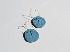 These bold modern statement hoop earrings are designed in textured effect, featuring simple color: grayish steel blue. They are slightly large, but still simple and minimal. Made of polymer clay, combined with stainless steel hoops, inspired by an abstract art. This jewelry is one of a kind and will definitely bring a vibrant touch to your every day's style or would be a beautiful accessory for a special occasion. ●The earrings will be packed in a small jewelry box●  MATERIALS -Polymer clay -Sta Blue Handmade Minimalist Hoop Earrings, Modern Blue Metal Earrings, Minimalist Blue Brass Earrings, Blue Artisan Earrings With Oxidized Finish, Artistic Blue Round Earrings, Statement Hoop Earrings, Small Jewelry Box, Simple Colors, Steel Blue