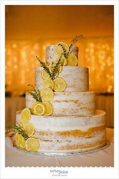 a wedding cake with lemons and rosemary on top