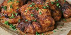 some meat with parsley on top of it in a wooden tray, ready to be eaten