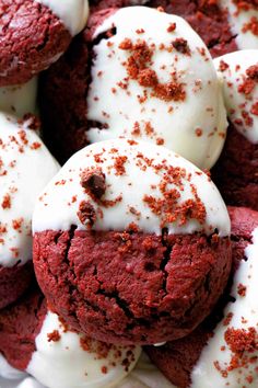 red velvet cookies with white frosting and sprinkles on top are shown