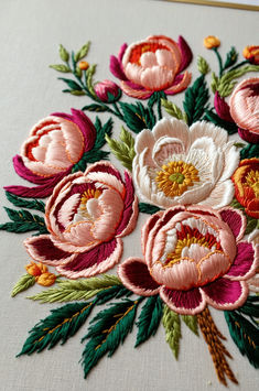 an embroidered piece of cloth with flowers on it