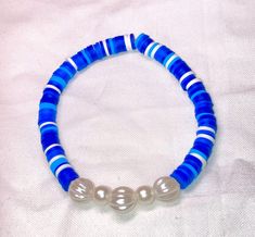 Cute blue and white beaded bracelet. These are high quality handmade bracelets. They are made with an elastic string so will fit lots of sizes. They are around 6.75 inches. Please note that each braclet will have a very similar beading pattern but not exactly identical. Blue Beaded Bracelets With 8mm Beads For Beach, Blue Hand-strung Pearl Bracelet With Round Beads, Blue Pearl Bracelet With Colorful Beads For Beach, Blue Beaded Pearl Bracelet For The Beach, Blue Beaded Pearl Bracelet For Beach, Blue Pearl Bracelet With Spacer Beads, Adjustable Hand-strung Blue Pearl Bracelet, Handmade Adjustable Blue Pearl Bracelet, Adjustable Blue Pearl Bracelet For Beach