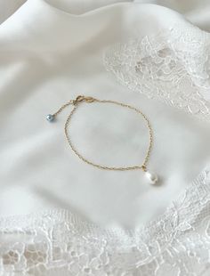 The perfect something blue gift!  A beautiful dainty freshwater pearl bracelet with a subtle something blue.  Can be worn on the wedding day or as an every day bracelet to remind the bride of that special day! Each bracelet is handmade to order in the USA Fully adjustable - just slide the gold/silver ball along the bracelet to achieve the desired length 14k Gold filled or Sterling Silver AAA Quality Genuine Freshwater Pearl, natural white color 6x8 mm 4mm Swarovski crystal or pearl at the end of each bracelet S/M 6-7 inches (fits most) or M/L 7-8 inches All orders come beautifully packaged and ready to gift for free! Matching Necklace: https://www.etsy.com/listing/1347129580/ Earrings: https://www.etsy.com/listing/886810982/ Bridal Something Blue Ideas, Something Blue Bracelet, Elegant Blue Pearl Bracelet With Charm, Elegant Adjustable Blue Pearl Bracelet, Elegant Blue Adjustable Pearl Bracelet, Adjustable Blue Pearl Bracelet For Wedding, Classic Blue Bracelets For Wedding, Dainty Blue Jewelry For Wedding, Elegant Hypoallergenic Pearl Bracelet For Bridesmaids