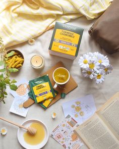 a table topped with books, tea and flowers