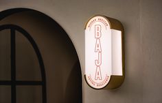 there is a sign that says baaca on the wall next to an arched doorway