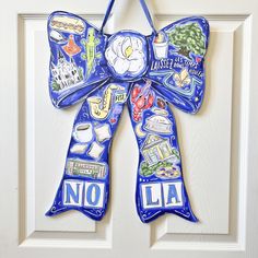 a blue door hanger decorated with pictures and words on it's front door