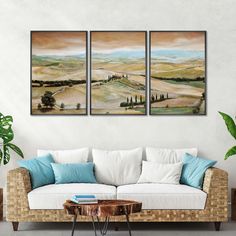 three paintings hanging on the wall above a couch