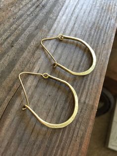 This style hoop earrings are a classic design and perfect for everyday wear. Each pair is forged by hand from recycled metals. Choose from rustic or raw copper or rustic or raw gold brass. Hoops are made to order just for you! Custom sizes available. Copper is the traditional gift for the 7th anniversary. It is also a versatile metal which makes it perfect for any occasion. MEASUREMENTS & SPECIFICS: Shown in rustic copper and raw brass. SIZE: approximately 3.5 x 4 cm (custom sizes available Small Hoop Jewelry For Everyday Use, Simple Adjustable Small Hoop Jewelry, Hand Forged Brass Jewelry For Everyday, Handmade Gold Wrap Earrings For Everyday, Adjustable Simple Small Hoop Jewelry, Handmade Metal Wrap Earrings, Handmade Metal Wrap Earrings For Everyday, Hoop Earrings With French Hook For Gift, Classic Hoop Earrings With French Hook As Gift