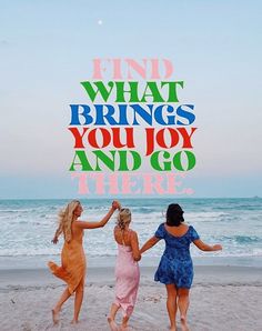 three women walking on the beach holding hands