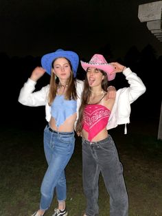 two girls in cowboy hats posing for the camera