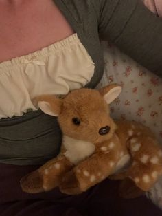 a woman holding a stuffed deer in her arms