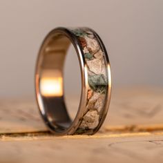 Pure Michigan that you can wear on your hand! This custom titanium band features Isle Royale Greenstone, Copper, and Petoskey Stone inlay. The stones are hand-harvested from the beaches and mines of Michigan’s Upper Peninsula, with the stone and copper fragments set in place by hand. The pieces are held in place by a durable epoxy and can be re-polished as needed, holding up very well over time with heavy use and active wear.CustomizableThis ring has optional personalized engraving, making it yo Isle Royale, Country Rings, Petoskey Stone, Thick Ring, Upper Peninsula, Hand Ring, Stone Inlay, Custom Ring, Ring Sale