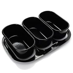 three black containers are stacked on top of each other in the shape of a rectangle