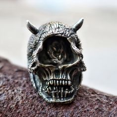 925 Sterling Silver Devil Cyclops Skull Ring With Horns [Weight] - 44g (US standard 10 size) [Size] - 38mm * 27mm [Material] - 925 Sterling Silver All sizes available! Just tell me the size you need. If you have any questions please send me an e-mail. This item is sent from Seoul - South Korea Item only by request and is made in the size you want. Order Processing time Please allow 5 to 10 days before shipping, as we don't carry a stock. all items need to make after order. please leave me your phone number in the box for Note to Seller during checkout.  Shipping items are sent by EMS to ensure that your order is delivered fast, on time and in a reliable manner. This is also the fastest and safest method for shipping my products.(I will provide tracking number) Shipping by EMS usually takes Collectible Gothic Skull Ring, Gothic Jewelry For Biker Events And Halloween, Handmade Metal Skull Ring, Gothic Skull Rings With Engraving, Gothic Oxidized Sterling Silver Skull Ring, Gothic Sterling Silver Skull Ring With Oxidized Finish, Gothic Skull Rings For Collectors, Punk Style Skull Ring For Halloween Collectible, Silver Skull Ring For Biker Events And Halloween