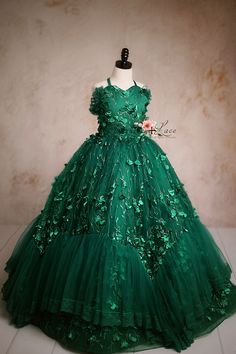 Elegant green ball gown with floral embellishments and a tulle skirt. Elegant Festive Tulle Dress, Fitted Floor-length Dress For Dress-up Events, Fitted Floor-length Dress For Dress-up, Holiday Pageant Tulle Gown, Holiday Tulle Gown For Pageant, Elegant Festive Tulle Princess Dress, Holiday Ball Gown With Ruffles For Weddings, Princess Style Wedding Gown For Christmas, Elegant Tulle Ball Gown For Christmas