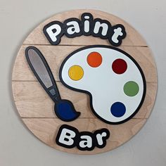 a wooden sign that says paint bar with a painting brush and palette on the front