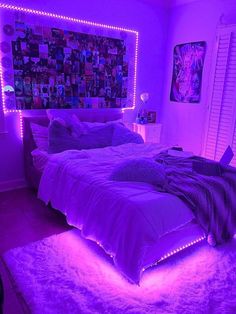 a bedroom with purple lighting and pictures on the wall above the bed, along with rugs