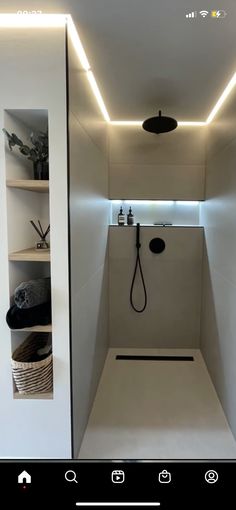 a bathroom with a shower and shelves in it