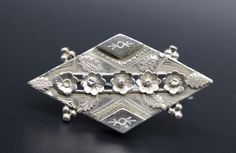 Antique Victorian sterling silver brooch made by the Ward Brothers in the Birmingham Jewellery Quarter and dating to 1889. A lovely sweetheart brooch designed in the Aesthetic Movement style. With beautiful repousse work and delicate fine chased detail. Fully stamped to the reverse with the Anchor mark for Birmingham, Lion and date stamp and WBS. Tube hinge pin and an early period 'C' clasp fastening.  Measurements Approx  width 4.25cm  The brooch is in lovely condition. Box not included. 💐Buy Birmingham Jewellery Quarter, Victorian Brooch, Antique Aesthetic, Hinge Pin, Aesthetic Movement, Sterling Silver Brooch, Silver Brooch, Antique Victorian, Birmingham