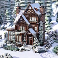 a large house with lots of snow on the ground and trees in front of it