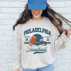 Rock the game day look with this vintage Philly sweatshirt! Retro oversized Eagles crewneck and trendy Philadelphia football sweatshirt--perfect for football fans. Ideal Eagle gifts and vintage Philadelphia fan gear!" Hello there! 😊👋 If you're on the hunt for some seriously cozy sweatshirts, you've come to the right place! I'm absolutely passionate about what I do, and my mission is to make your shopping experience absolutely perfect. If you ever have any questions, concerns, or just want to chat about my products, feel free to reach out to me anytime. Let's dive into The fantastic features of these sweatshirts ⭐ Cozy Material: Our sweatshirts are made with a warm and comfy 50% cotton, 50% polyester blend (8.0 oz/yd² or 271.25 g/m²) for those chilly days. ⭐ Stylish Fit: Enjoy a classic f Eagles Crewneck, Philly Football, Vintage Philadelphia, Crewneck Vintage, Retro Sweatshirts, Football Sweatshirt, Sweatshirt Vintage, Oversized Style, Cozy Sweatshirts