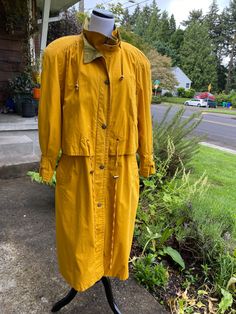 Casual Fall Raincoat With Button Closure, Fitted Long Sleeve Raincoat For Spring, Hooded Mustard Outerwear For Fall, Mustard Hooded Outerwear For Fall, Cotton Raincoat For Fall, Fitted Casual Raincoat For Fall, Cotton Long Sleeve Raincoat For Fall, Yellow Buttoned Spring Outerwear, Yellow Buttoned Outerwear For Spring