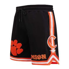 Upgrade your collection of Clemson Tigers gear by picking up these Classic shorts from Pro Standard. On the front of both legs and on each side, there are several eye-catching graphics and appliques that are sure to emphasize your unwavering passion. The drawstring-adjustable elastic waistband ensures you'll be able to maintain a comfortable fit throughout every wear, especially on Clemson Tigers game day. One rear zippered pocket Elastic waistband withdrawstring Machine wash, tumble dry low Off Collegiate Style Short Bottoms For Game Day, Collegiate Cotton Bottoms For Sports Events, Collegiate Cotton Athletic Shorts, Classic Shorts, Orange Moisture-wicking Sportswear Shorts, Clemson Tigers, Game Day, Tigers, Zipper Pocket