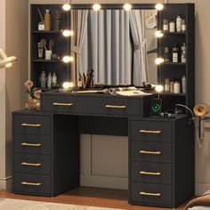 a black vanity with lights on it in front of a mirror and desk area next to a bed