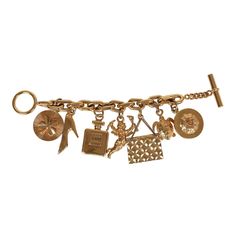 This 80's iconic vintage Chanel lucky charms bracelet features a 24K gold plated chain link with seven of Chanel's "iconic" lucky charms including a clover, shoe, perfume bottle, cherub, Chanel quilted handbag, turtle, and camellia flower. It also has a bar toggle and loop closure.Origin: FranceCondition: Vintage; Very Good - The charm bracelet shows sign of wear with scratching throughout. Some of the charms have chipped/peeled around the corners. There's some discoloration.Measurements: Length Luxury Vintage Style Jewelry With Vintage Charm, Classic Luxury Gold Charm Bracelet, Shoe Perfume, Lucky Charm Bracelet, Quilted Handbag, Camellia Flower, Charms Bracelet, Gold Charm Bracelet, Lucky Charms