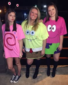 three girls in costumes standing next to each other